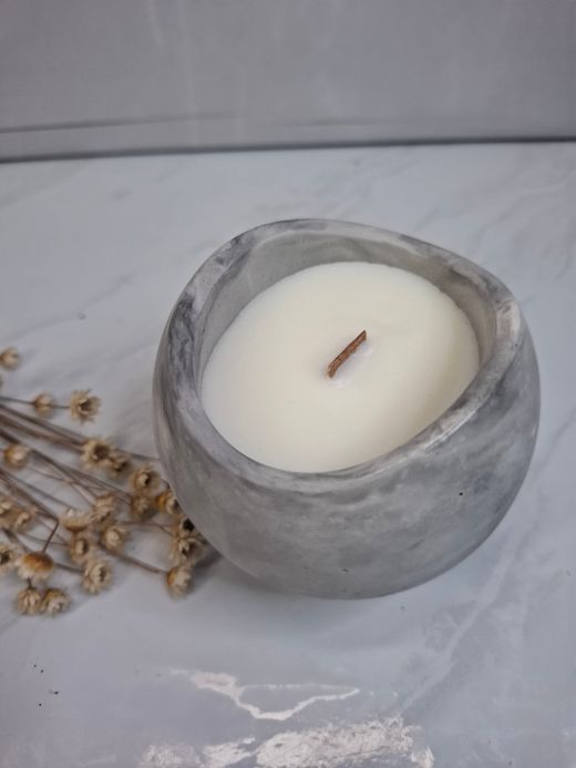 Vela aromática artesanal en recipiente esférico efecto mármol