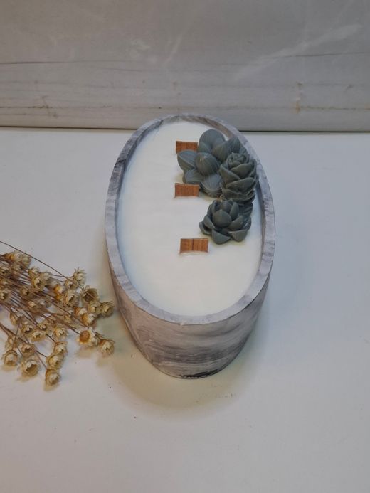 Vela artesanal en recipiente ovalado efecto mármol